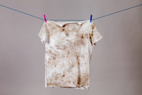 Photo of soiled t-shirt hanging on clothesline