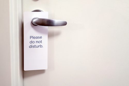 Photo of "Do Not Disturb" sign hanging on door